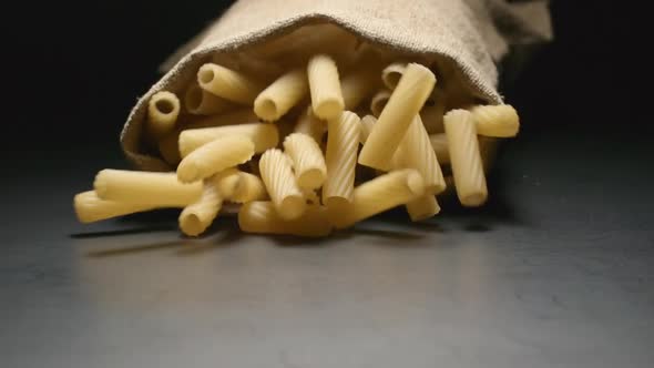 Cloth bag falls and pasta (tortiglioni) fall out of him