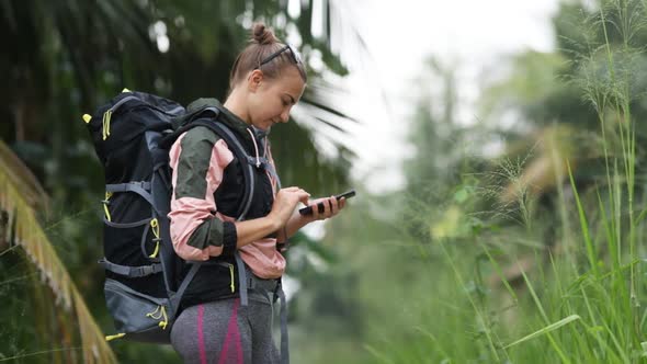 White Caucasian attractive girl with a large tourist backpack alt