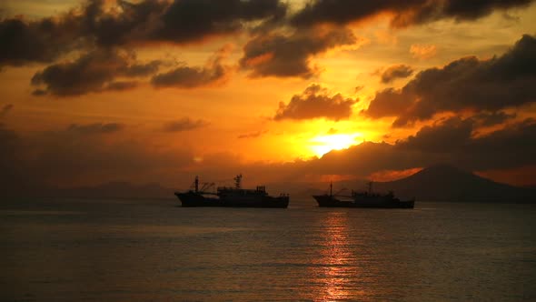Fishing Boats on Sea in Sunset Lights in Sanya, Hainan, China alt