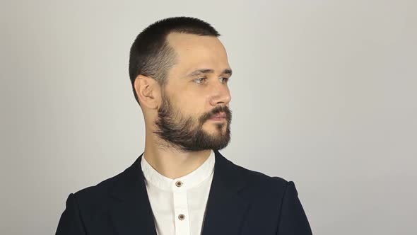 Young Successful Businessman Shows His Forefinger To the Side