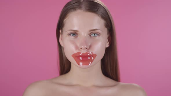 Beautiful Woman Wearing Lip Mask and Posing alt