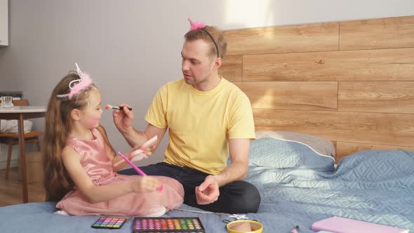Father and Daughter Playing at Home with Make Up Brush Doing Makeup