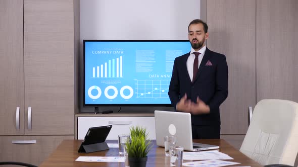 Businessman in Front of Big TV alt