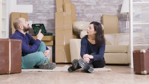 Couple Sitting on Carpet in Their New Apartment alt