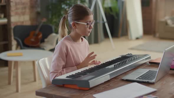 Girl Having Online Music Lesson alt