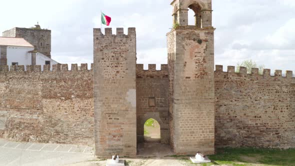 Aerial drone view of Mourao castle with alqueva dam lake behind alt
