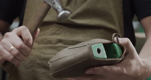 Close Up View of Tailor Nailing and Fixing Blank for Shoes in Private Leather Craftshop with Pliers