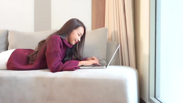 Young asian woman use laptop alt