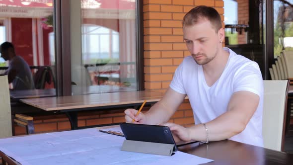 Construction engineers checks the blueprints of the business center. alt