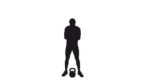 Silhouette Of Male Athlete Pushing Kettlebell By One Hand