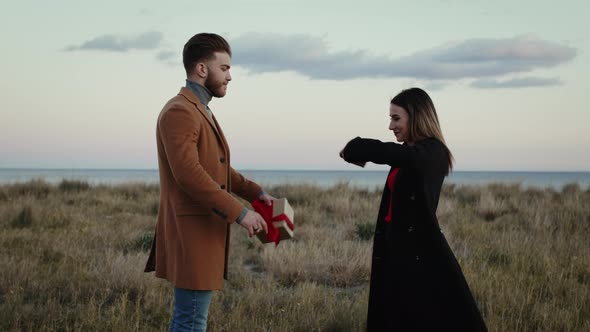 Engaged Couple Exchanges Gifts alt