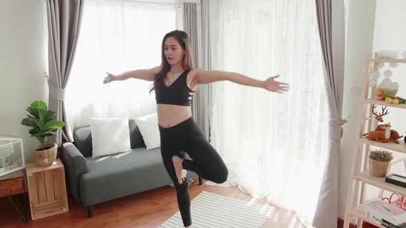 Sport women lovey with yoga exercise and stretching in the living room at home alt