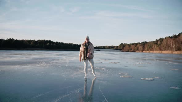 Woman Ice Skating on a Frozen Lake on a Sunny Winter Day Approaching the Camera