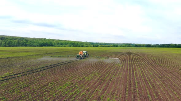 Aerial View Farm Machinery Spraying Insecticide To the Green Field, Agricultural Natural Seasonal alt