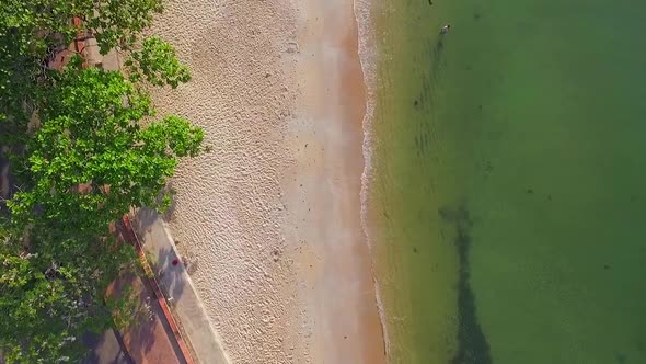 Aerial view above of a calm beach with ripple water, Kep, Cambodia. alt