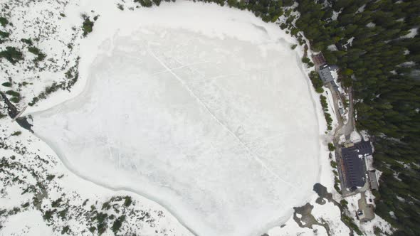 Frozen Poprad lake (Popradske pleso), High Tatras National Park, Slovakia Aerial alt