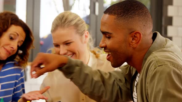 Group of executives interacting while having lunch 4k alt