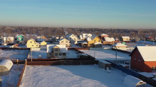 A Small Village in the Middle of a Pine Forest in Winter After Snowfall on a Bright Sunny Day