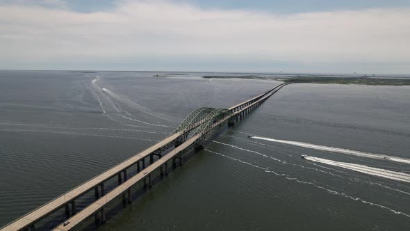 An aerial view of the Great South Bay Bridge on a cloudy morning. The drone camera truck right and p alt