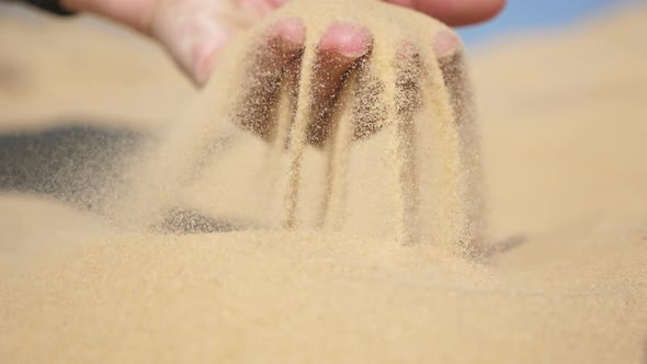 Kid`s Palm Raising Dry Sand and Streaming It Down Through Spread Fingers in Slo-mo