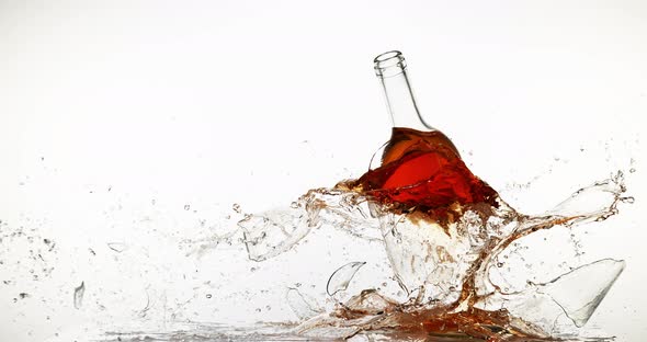 900134 Bottle of Pink Wine Breaking and Splashing against White Background, Slow motion 4K alt