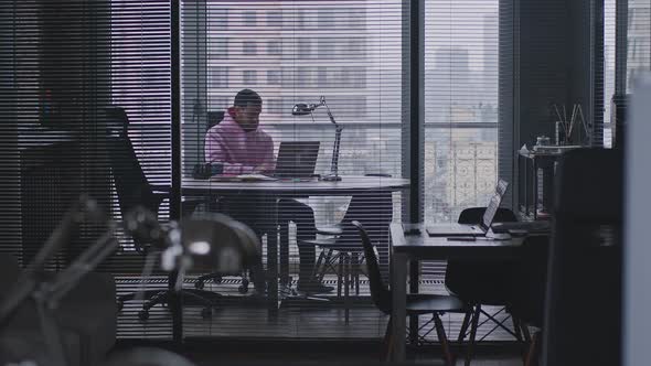 A Young Handsome Man Works in an Office Space alt