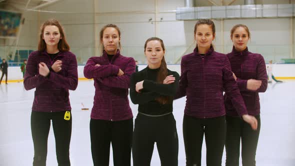 Curling Training - the Judge Standing on the Ice Rink with Her Women Students - Crossing Their Hands alt