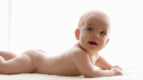 Baby boy lying on his front alt