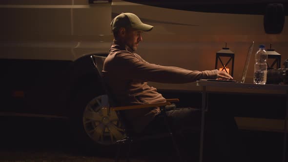 Men Working From Remote Outdoor Place Using His Laptop and Internet alt