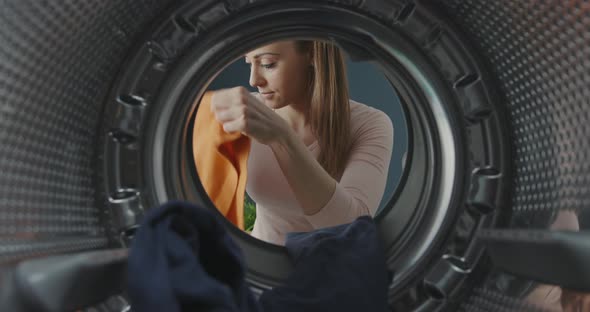 Woman loading the washing machine