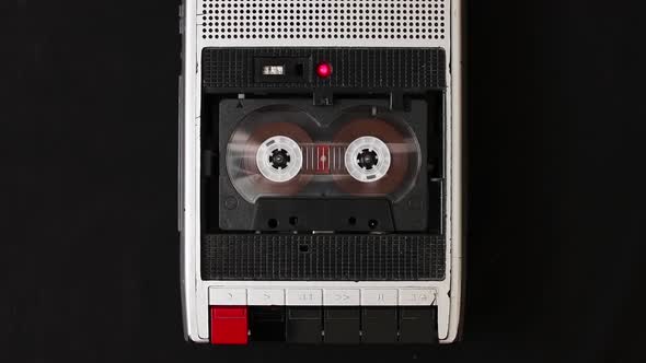 Audio cassette tape rolling in vintage player