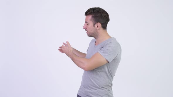 Young Happy Hispanic Man Presenting Something alt