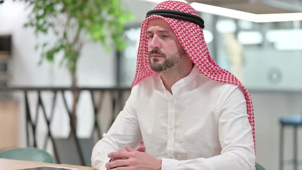Serious Arab Businessman Looking at Camera  alt