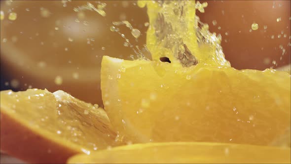 Slow Motion Shot of Orange Juice Splashing Through Orange Slices at 1400Fps alt
