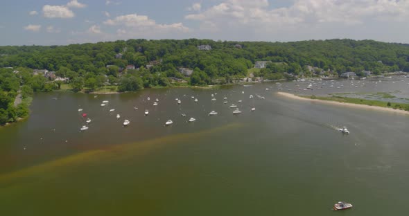 Flying Towards Boats Anchored on Harbor and Aerial View of Houses Amongst Trees alt