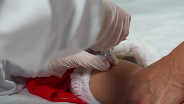 doctor with syringe vaccinating child baby flu vaccine, injection shot in leg
