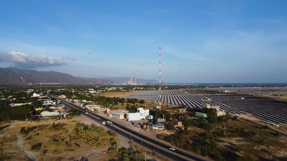 Solar panel photovoltaic base station with electricity pylon and busy traffic highway road, zero emi alt