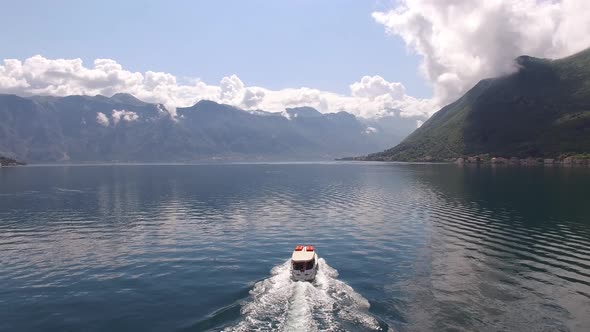 Passenger Ferry Sails Along the Kotor Bay with the Mountains in the Background alt