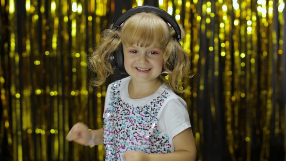 Child Dances, Sings, Listens Music on Headphones. Little Kid Girl Having Hun, Relaxing and Enjoying alt