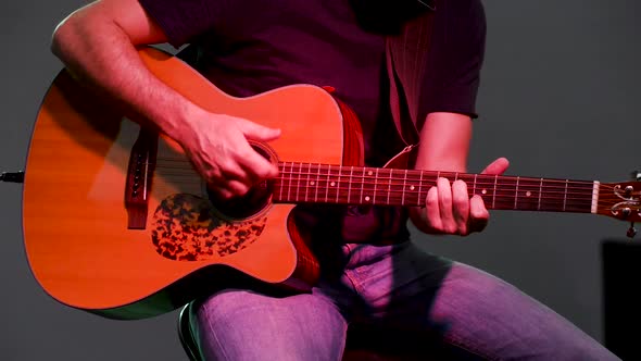 Person playing guitar in concert live alt