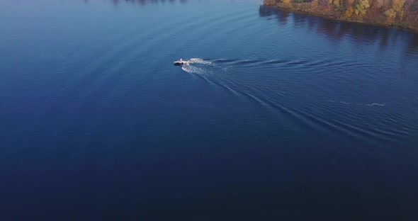 Flight Over the River with Floating Boats with Windsurfing and Views of the Island Autumn