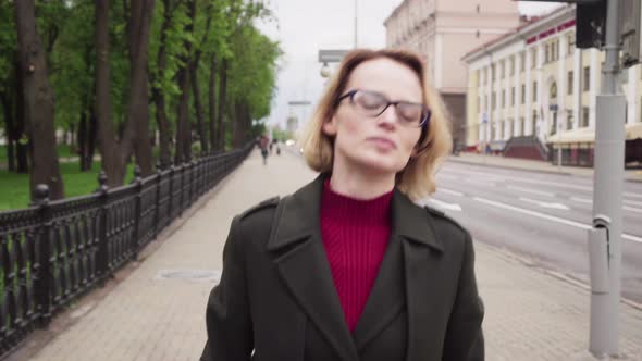 Sad Woman Walking on City Street alt