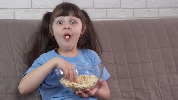 Watching TV with popcorn. alt