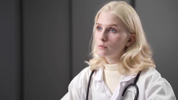 Attractive Mixedraced Female Doctor Working in Medical Office alt