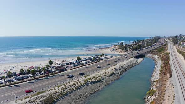 Drone shot over Cardiff-by-the-sea beach and highway 101 on the West Coast of America alt