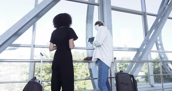 Couple of Newlywed Teenagers Standing in Airport Terminal at Station Wearing Medical Masks with alt