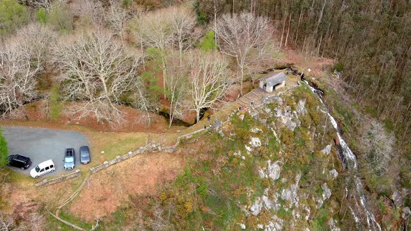 viewpoint with cars and people in nature overlooking the waterfall on the cliff with eucalyptus tree alt