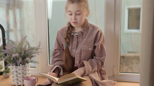Girl with a Book Near the Window