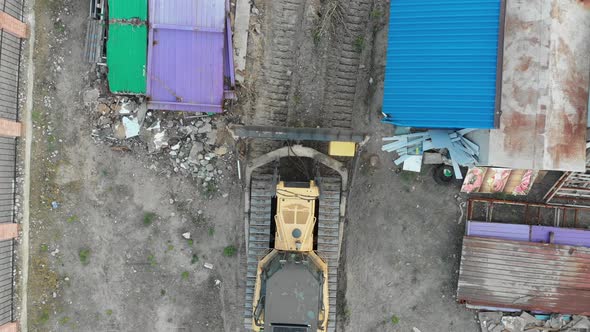 Top Aerial View on Tracked Bulldozer Rides on Sandy Road at Construction Site alt