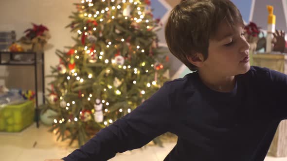 Caucasian boy decorating homemade gingerbread cookies with sugar icing, using a piping pastry bag, b alt